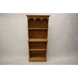 A modern pine waterfall bookcase, with gallery top, plinth base, 60 cm x 22 cm x 140 cm high