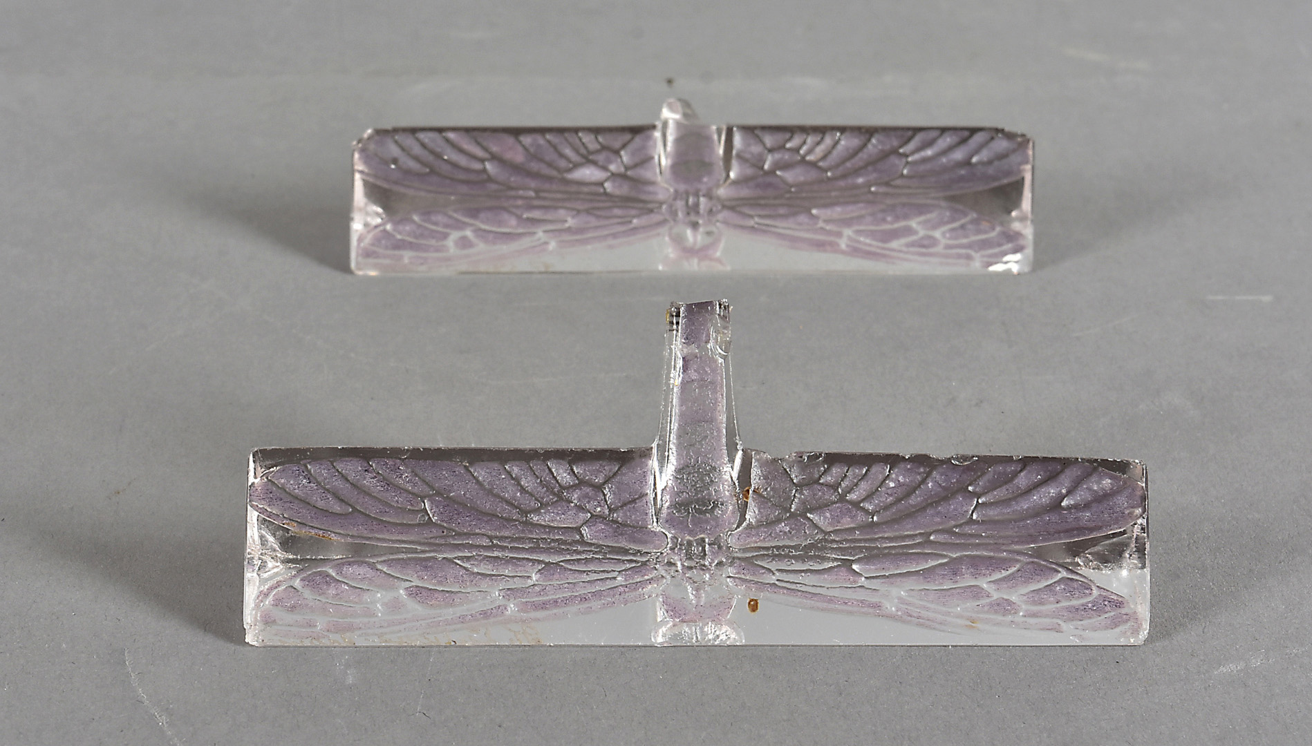 A pair of R Lalique dragonfly Libellule knife rests, stained amethyst, signed to side R Lalique