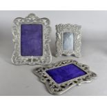 A pair of silver plated photograph frames, having pierced swag design, together with another