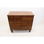 A 19th Century mahogany chest of drawers, having three long drawers on four turned legs, turned