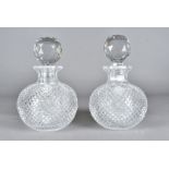A pair of spherical hobnail cut decanters and stoppers, having diamond shaped design to the cut