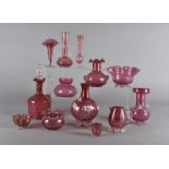 A quantity of cranberry glassware, including a decanter and stopper, a twin handled vase with