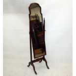 A Windsor and Neate of Newbury walnut cheval mirror, with shaped top supported on arched bracket