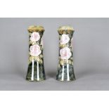 A pair of Royal Doulton vases, tube line decorated with pink roses against a green mottled ground,