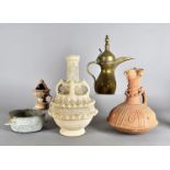 A large collection of various middle Eastern ceramics, including terracotta jugs, ancient oil