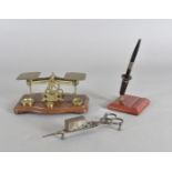 A set of postal scales, a bakelite pen stand, a pair of Victorian candle snuffers and a 1972