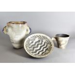 Three contemporary pottery vessels, including a Nick Weaks bowl with waves and sunburst decorated