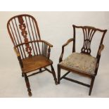 A 19th Century elm hoop back armchair, with turned arm rest supports on four turned legs and cross