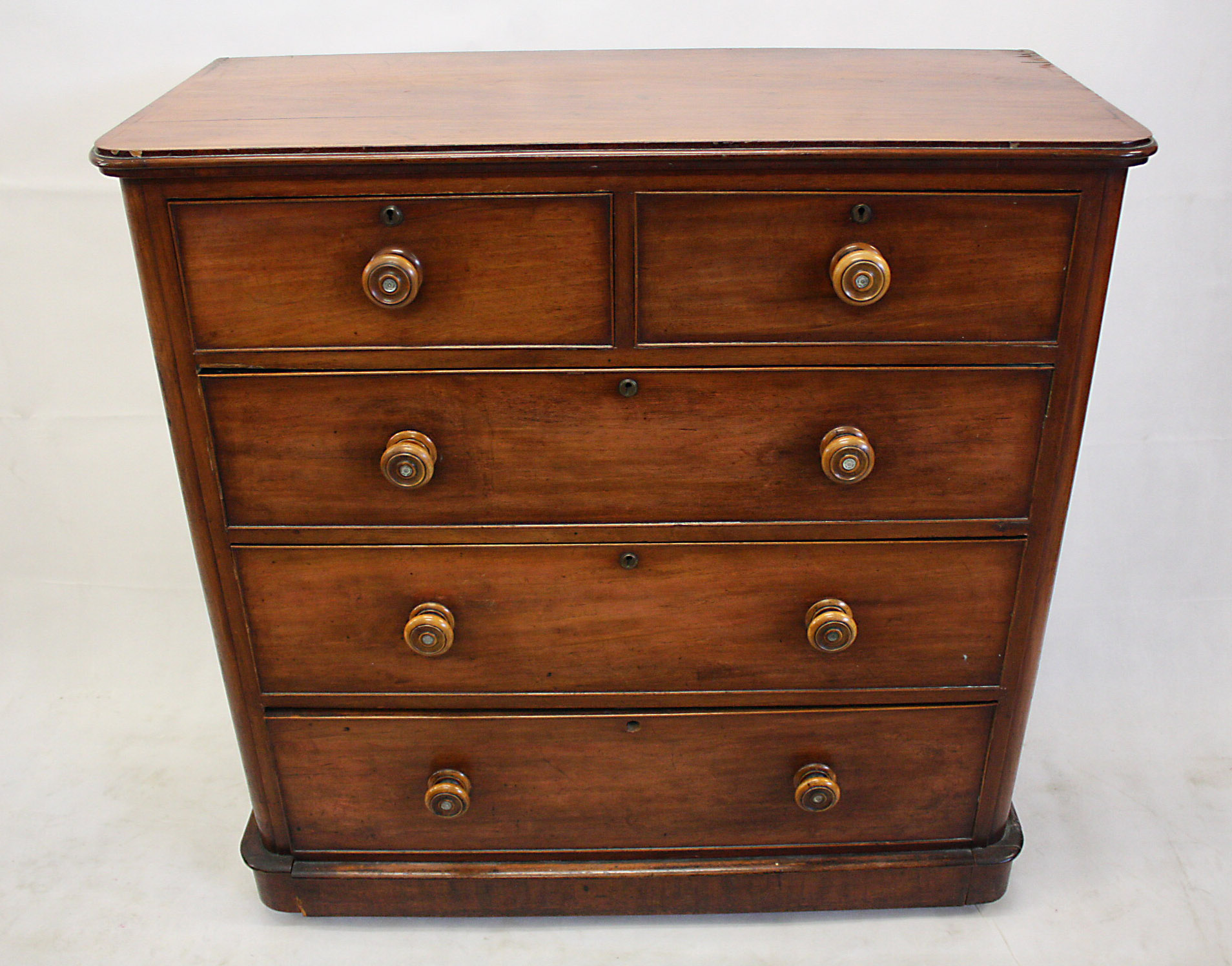 A 19th Century mahogany veneered chest of drawers, two short over three long drawers, turned handles