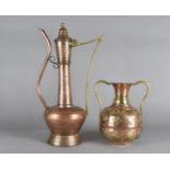 An Italian copper wine ewer with brass handle, 52 cm high and a copper and brass twin handled middle