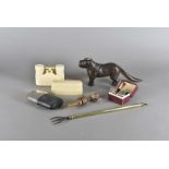 A collection of miscellaneous items, including a telescopic toasting fork, a cast iron dog nut