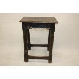 A 17th Century oak joint stool, the rectangular moulded top supported on a shaped apron on tapered