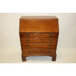 An Edwardian mahogany bureau, having fall front over four graduated long drawers on bracket feet, 75