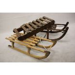 Three scratch built child's sledges, with metal mounts and pull strings (3)