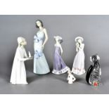 A Lladro figure group, young girl with chamber stick, two other Lladro figures of girls with