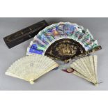 A 19th Century Chinese lacquer and paper fan, the mount painted with figures within palaces having