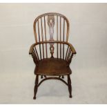 A 19th Century elm hoop back armchair, with pierced back splat, shaped seat and crinoline stretcher