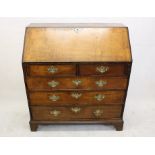 A George III oak bureau, having two short over three graduated long drawers under fall front to