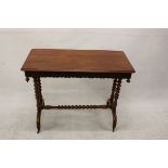 A 19th Century walnut side table, having a shaped apron, drop finials, turned supports on arched