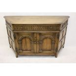 A reproduction oak court cupboard, single frieze drawer over a pair of arched panel doors, 136 cm