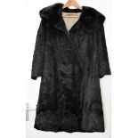 A black pony skin three quarter length fur coat by Debenham & Freebody, with a gold silk lining