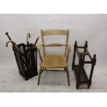 Two 20th Century oak stick stands, and an elm kitchen armchair together with various sticks (