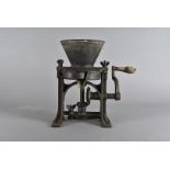 A cast iron Victorian paint grinder, with ratchet and pin mechanism, soft wood handle, 31 cm high