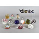 A quantity of glass paperweights, together with four iridescent glass birds