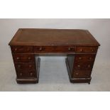 An early 20th Century mahogany pedestal desk, having central long drawer flanked by two short