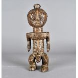 A carved tribal figure, possibly LUBA, the figure of a male, having carved tribal markings to the