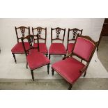 An Edwardian stained beech salon suite, comprising five single chairs with vase shaped splats and an