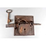 A late 18th/early 19th Century iron lock and key, the large sized lock with deadbolt style