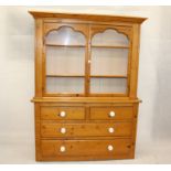 An Edwardian pine dresser, having glazed top section with double doors to three shelf interior
