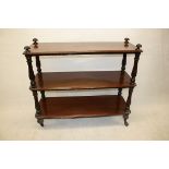 A William IV mahogany buffet, the three tiers supported on carved lobed columns, bun feet and