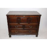 An 18th Century oak and elm mule chest, the carved panel front with two short over one long base