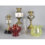 Three 19th Century and later oil lamps, together with associated shades and chimneys