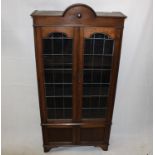 An Edwardian glazed oak bookcase, with panel doors to base, bracket feet, 94 cm x 197 cm high x 31