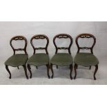 Four Edwardian balloon back dining chairs, with scroll and floral carved back rests (4)