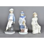 Three Lladro figures, modelled as boys, one with pond yacht, one dressed as a clown seated upon a