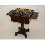 A William IV rosewood games table, the square top with egg and dart border with push up top fitted