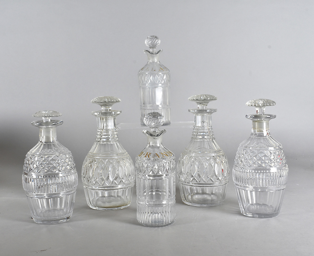 Three pairs of cut glass decanters and stoppers, including one marked Hollands and another Brandy,