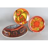 Three Poole pottery Delphis bowls, all various designs and sizes, decorated in vibrant colours,