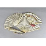 An 18th Century bone and paper fan, the mount decorated with a hand coloured print of figures within