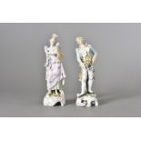 A pair of German porcelain figurines, of a fashionable couple, in coloured enamels, factory mark