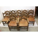 A set of twelve reproduction oak framed dining chairs, having arched supports with acorn drop