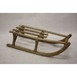 A child's sledge, having metal mounts and rungs, 78 cm long