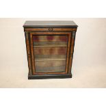 A 19th Century walnut and ebonised pier cabinet, glazed panel door to three shelf interior, gilt