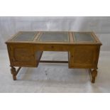 A Jaycee Furniture Ltd oak veneered desk, with carved frieze drawer flanked by carved panel doors,