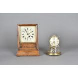 A Victorian mantel clock, having brass metal movement encased within wooden frame, the dial