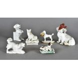 A collection of continental porcelain dogs, including a match strike spaniel, a begging dog match